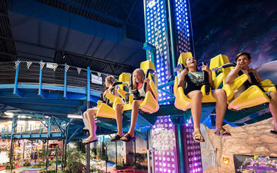 a bunch of kids riding a run ride at Tom Foolerys Adventure Park