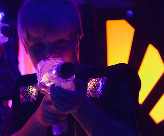 little boy playing laser tag
