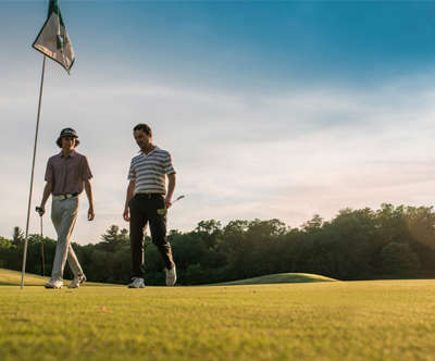 Two gentlemen walking through Trappers Turn Golf Course.