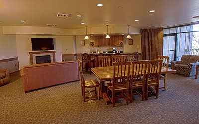 Royal Hospitality suite dining room with a living room and kitchen in the background