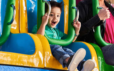 a little boy enjoying a ride at Tom Foolerys Adventure Park
