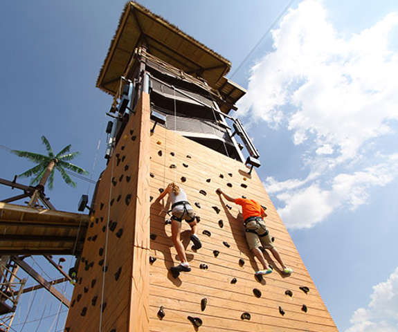 couple kids climbing the rock wall at safari outdoor adventure park