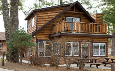 Lake Delton Waterfront Cabin with two picnic tables outside