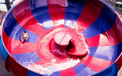 woman swirling around on a water slide