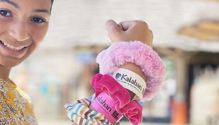 Girl showing off her hair scrunchies and Kalahari Waterpark wristbands