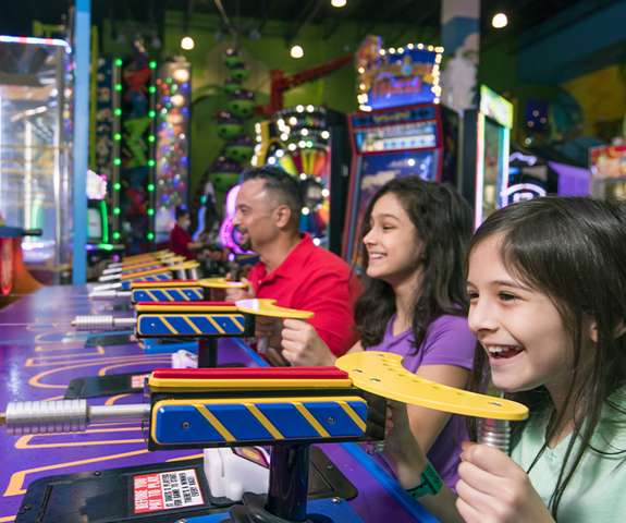 Family playing in the arcade